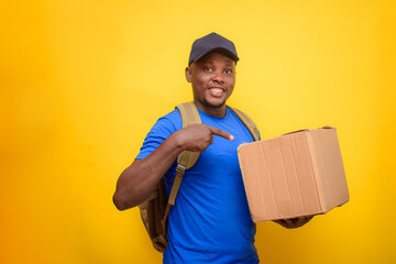 An African dispatch man with face cap, pointing to the boxes he is carrying on his shoulder
