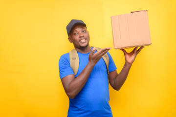 An African dispatch man with face cap, pointing to the boxes he is carrying on his shoulder
