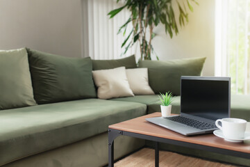 Work from home, workspace concept, gray laptop on table with cup of coffee