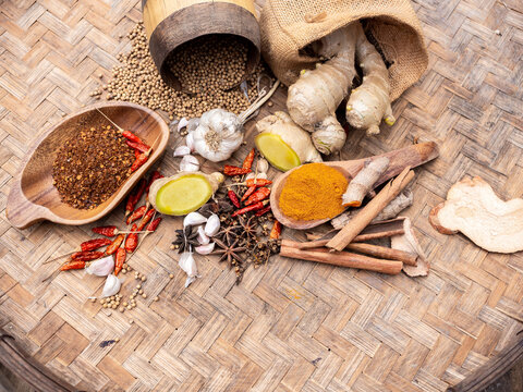 Top view of colourful spices in wooden tray. Asian popular cooking ingredients, dry hot healthy cook herbs. view form above and copy space background.