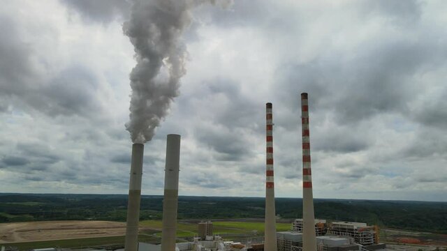 Smokestacks with a cloudy sky background