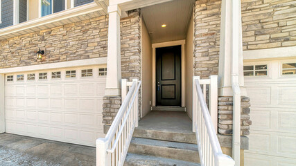 Pano Townhouse entrance with concrete stairs leading to front door under a portico