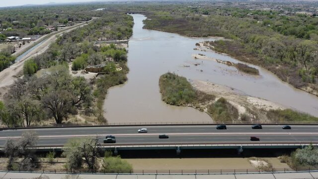 Commuting Traffic on Highway Road Bridge over Rio Grande River - Aerial