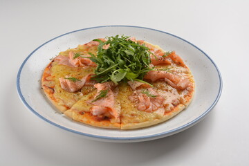 baked cheesy pizza with smoked salmon seafood and salad in white background western halal menu