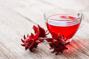 Roselle fruit (Jamaica sorrel, Rozelle or hibiscus sabdariffa) and glass cup of roselle juice tea  © NIKCOA
