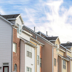 Square Townhouses facade on a picturesque neighborhood with Wasatch Mountain peak view