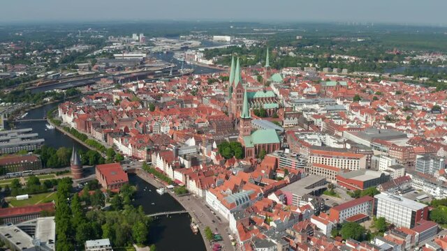 Aerial panoramic view of medieval city centre with tall churches towers. Historic town surrounded by river Trave. Luebeck, Schleswig-Holstein, Germany