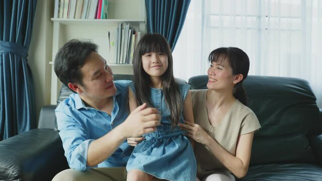 Portrait of Asian happy family, sit on sofa in living room at house.