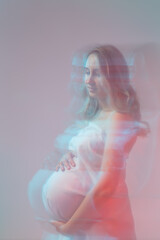 Naklejka premium Elegant pregnant young woman standing wearing light fabric. Pregnancy, fantasy and fairy tale concept.