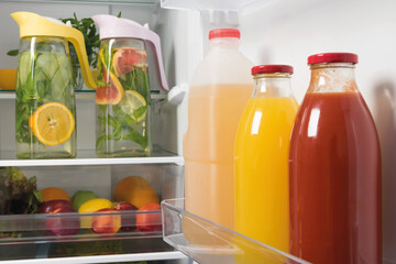 in refrigerators bottled juice and lemonade from fresh fruit in decanters, storage of drinks in...