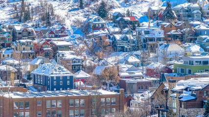 Pano Sunlit neighborhood on a snowy winter mountain setting in scenic Park City Utah