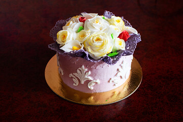 Fototapeta na wymiar Beautiful birthday cake with mastic flowers decor.