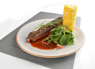 pan fried bbq fresh cod, salmon, grouper fish fillet in chef sauce with potato, corn and vegetables western halal menu