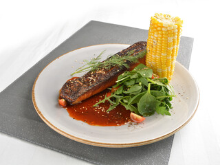 pan fried bbq fresh cod, salmon, grouper fish fillet in chef sauce with potato, corn and vegetables western halal menu