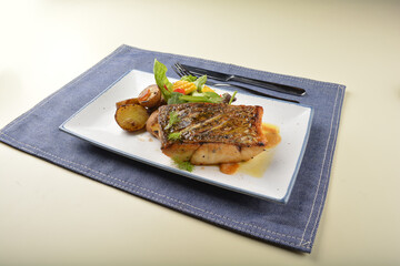 pan fried bbq fresh cod, salmon, grouper fish fillet in chef sauce with potato, corn and vegetables western halal menu