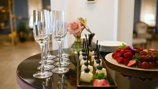 glasses with champagne and fruits on buffet table at a restaurant or in the hotel lobby
