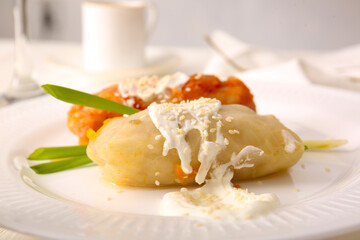 Plate with tasty stuffed cabbage rolls on light background, closeup
