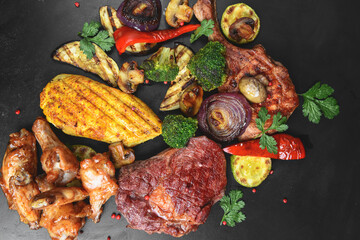 Hot spicy fried set. Grilled chicken, pork and beef over black background, with BBQ vegetables.