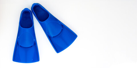 Blue flippers on a white background. Baner Flat lay. Copy space © BashevaOlga