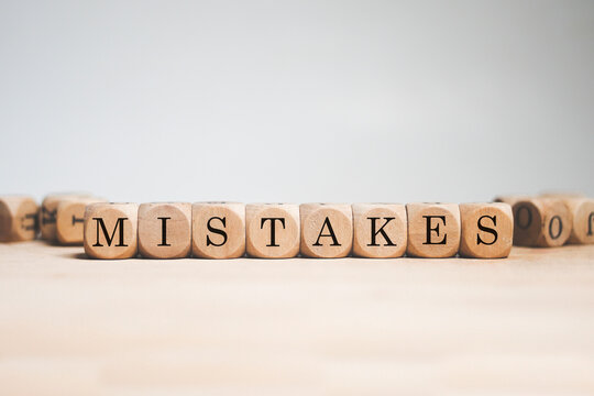 Mistakes word cube on white background