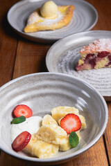 Vanilla cream dessert with sour cream and fresh organic strawberry. Served in a traditional bowl.