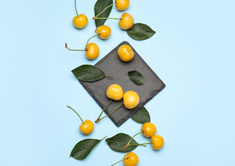 Tasty sweet cherries on color background
