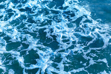 Deep blue and rough sea with lot of sea spray.Blue background.Soft focus,blurred image.