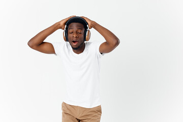 man with headphones listening to music with eyes closed enjoyment