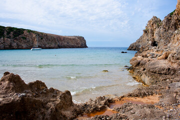 Fototapeta na wymiar Paradise beach with clear water and cliffs and rocks