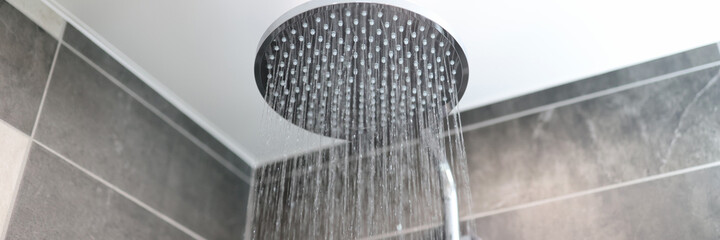 In bathroom, water flows from shower tap
