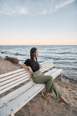 Lonely woman on the beach. COncept photo of depressed emotion and loneliness