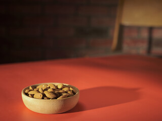 Plate with almonds on the table
