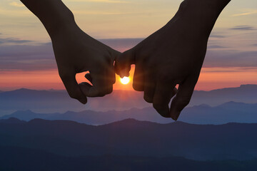 Couple hold hands in nature on tof of mountain  insunset time,vacation and relax concept,copy space...
