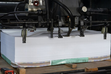 A stack of paper is loaded into a typewriter