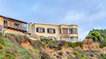 Fototapeta na wymiar Pano Buildings on steep land with cloudy blue sky background in San Diego California