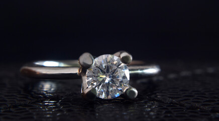 The wedding ring is white gold decorated with diamonds.