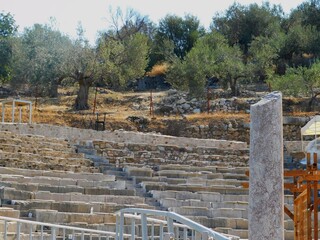 Fototapeta na wymiar A small ancient theatre, used for musical performances, in the town of Palea Epidavros