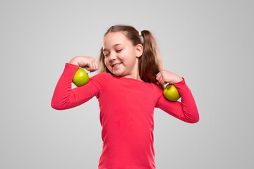 Strong healthy kid with green apples