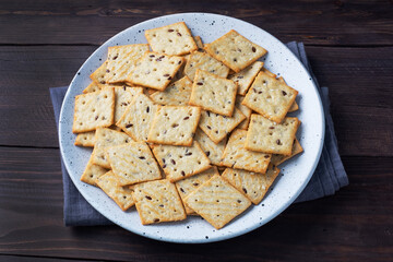 Delicious healthy cookies crackers with flax seeds and sesame seeds on a plate. Background of a healthy snack food, close up.