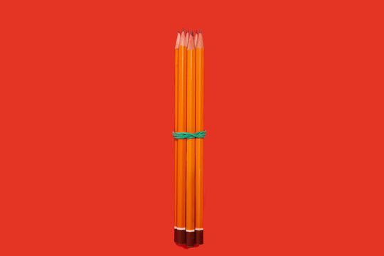 Pencils Lying On A Red Background. School Accesories