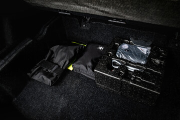 First aid kit and car kit emergency tools in trunk of luxury car.