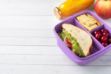 Delicious healthy sandwich in a lunch box, cookies and cherries. Take lunch with you to school or...