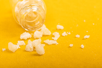 narcotic salt crystals amphetamine on yellow background - obrazy, fototapety, plakaty
