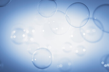 Blurred Transparent Blue Soap Bubbles Floating with Center Copy Space.