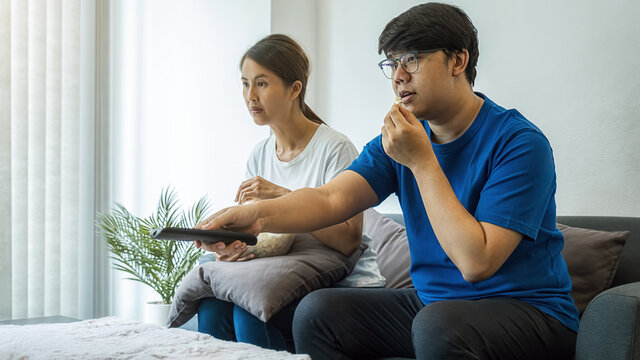 Asian Family Watching Movies On Television At Home In Long Weekend.