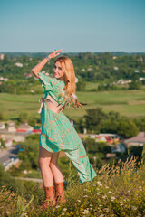 Vintage Boho style, girl in satin dress and boots at sunset, fashionable clothes and details. Summer style