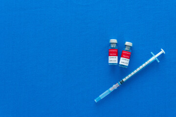 Topveiw Vaccine and syringe injection on blue background. It use for prevention,immunization and treatment from corona virus infection. Medicine infectious concept.