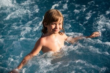 Cute boy swim in pool. Active healthy kids lifestyle, water sport activity and lessons for summer family vacation with child.