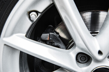 Car wheel braking system. Modern car brake disc with caliper.
