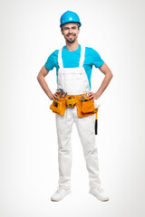 Confident repairman in uniform with tool kit
